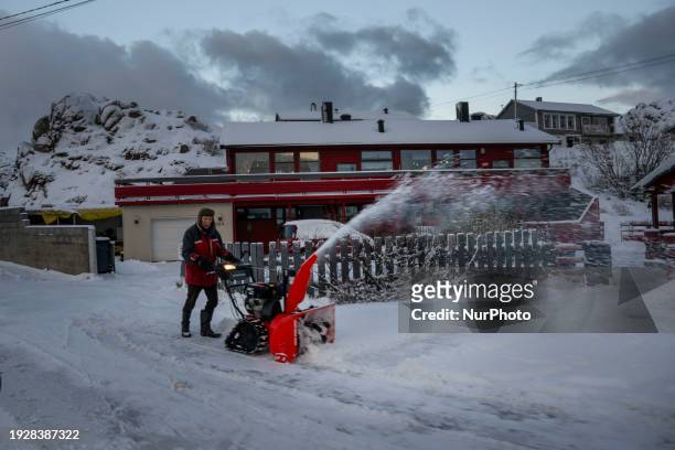 Person is removing snow from one of the streets in Honningsvag, Norway, on January 9, 2024. Honningsvag, situated on the island of Mageroya, is...