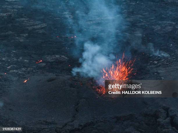 An aerial view taken on January 15, 2024 shows volcanic activity near Grindavik, western Iceland after an eruption. Volcanic activity in southwest...