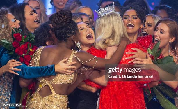 Miss Colorado Madison Marsh, receives a joyful hug from the other contestants after winning the Miss America 2024 pageant at the Dr. Phillips Center...