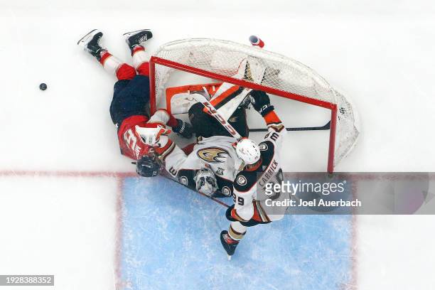 Brandon Montour of the Florida Panthers collides with Goaltender John Gibson of the Anaheim Ducks during third period action at the Amerant Bank...