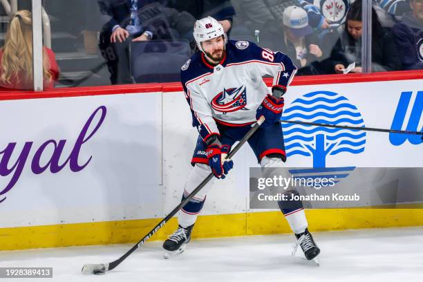 Kirill Marchenko of the Columbus Blue Jackets plays the puck during third period action against the Winnipeg Jets at Canada Life Centre on January...