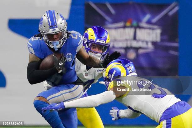 Detroit Lions running back Jahmyr Gibbs runs the ball while Los Angeles Rams cornerback Cobie Durant and safety Quentin Lake defend during the first...