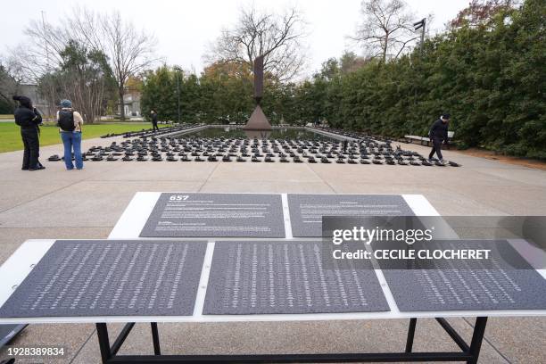 People visit an installation by artist Sandeigh Kennedy of 657 pairs of shoes in memory of the more than 600 mass shootings that occurred in the...