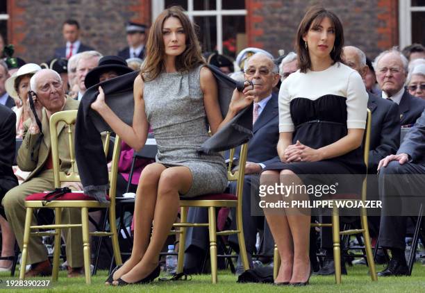 French First lady Carla Bruni-Sarkozy and British First Lady Samantha Cameron attend a ceremony at the Royal Hospital Chelsea in London on June 18,...