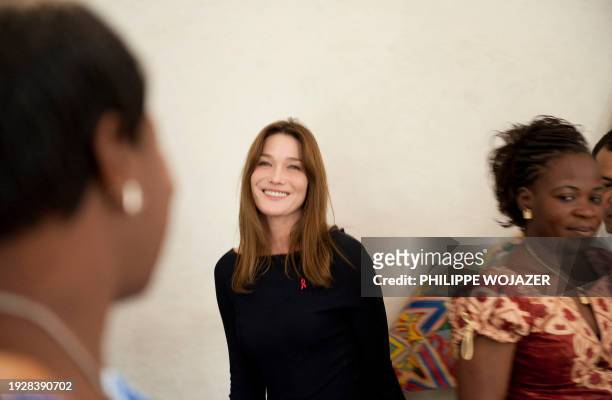 France's first lady Carla Bruni-Sarkozy walks among guests at a lunch at the residence of the French Ambassador in Ouagadougou on February 11, 2009....