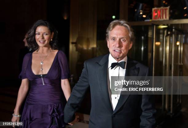 Actors Michael Douglas and his wife Catherine Zeta-Jones arrive to attend an award ceremony during which French President Nicolas Sarkozy will...