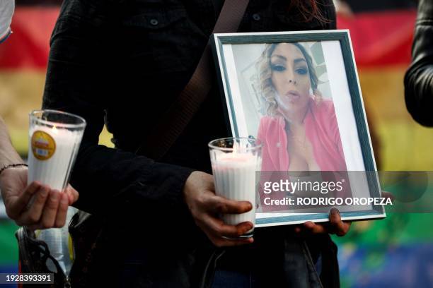 Demonstrator holds a candle and a picture of trans woman activist Samantha Gomes as members of the LGBTQ community take part in a protest following...