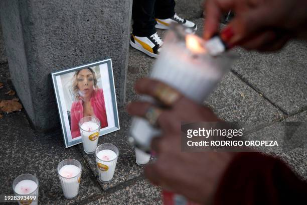 Demonstrator lights a candle next to a picture of trans woman activist Samantha Gomes as members of the LGBTQ community take part in a protest...