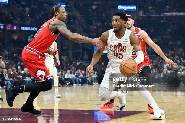 Donovan Mitchell of the Cleveland Cavaliers drives to the basket against DeMar DeRozan of the Chicago Bulls during the first half at Rocket Mortgage...