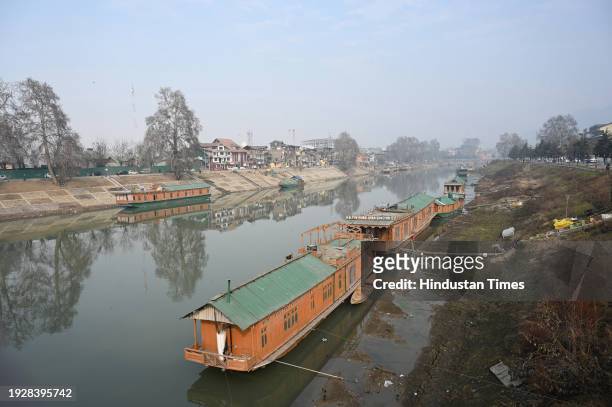 Houseboats are seen on the banks of Jhelum river on January 15, 2024 in Srinagar, India. Water level in Jhelum hits lowest as dry spell continues.