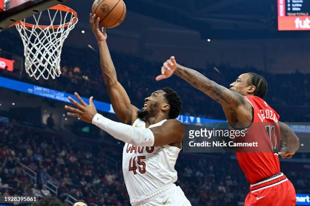 Donovan Mitchell of the Cleveland Cavaliers shoots over DeMar DeRozan of the Chicago Bulls during the first half at Rocket Mortgage Fieldhouse on...