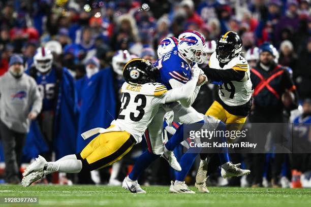 Josh Allen of the Buffalo Bills runs with the football during the first half of the NFL wild-card playoff football game against the Pittsburgh...