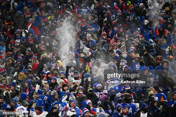 Buffalo Bills fans throw snow after a touchdown was scored during the first half of the NFL wild-card playoff football game against the Pittsburgh...