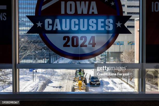 Icicles hang from a skywalk window as a snow plow clears streets downtown as severe freezing temperatures and snow have gripped Iowa during Iowa...