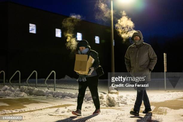 Condensation forms as Deborah Stoner, left, of Ames, Iowa, and her dad Michael Porter, Sr. Of Huntington Beach breath the sub-zero air on a snowy...