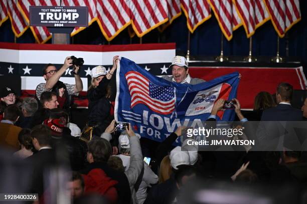 Supporters of former US President and Republican presidential hopeful Donald Trump celebrate at a watch party during the 2024 Iowa Republican...