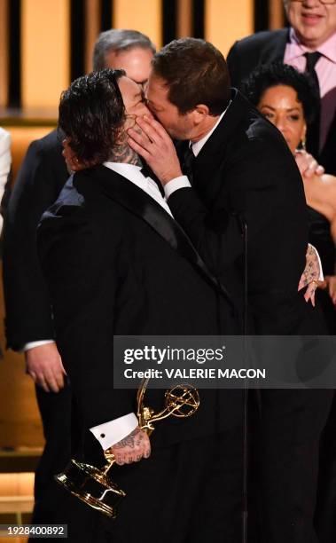 Actor Ebon Moss-Bachrach kisses Canadian chef and actor Matty Matheson as the cast and crew of "The Bear" accept the award for Outstanding Comedy...