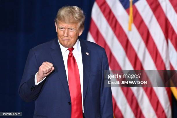 Former US President and Republican presidential hopeful Donald Trump arrives at a watch party during the 2024 Iowa Republican presidential caucuses...