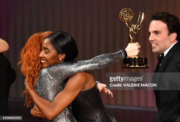 Actress Natasha Lyonne hugs US actress Ayo Edebiri as she presents the cast of "The Bear" the award for Outstanding Comedy Series onstage during the...