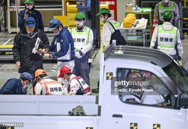 Japanese transport ministry officials test the safety of a Daihatsu Motor Co. Vehicle at its factory in Ryuo in Shiga Prefecture, western Japan, on...