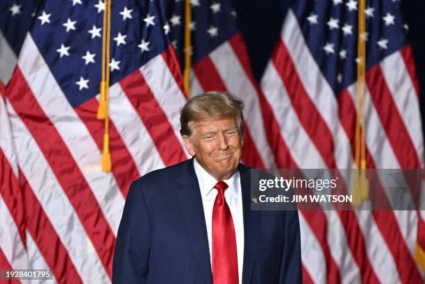 Former US President and Republican presidential hopeful Donald Trump attends a watch party during the 2024 Iowa Republican presidential caucuses in...