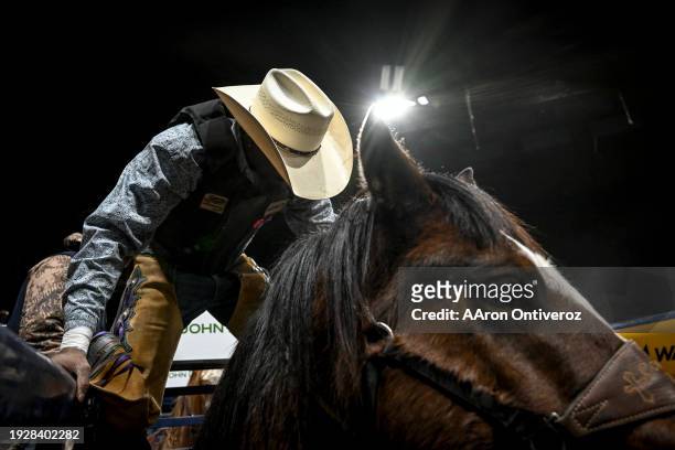 Marcus Verser Sr. Mounts his bronc during the MLK Jr. African-American Heritage Rodeo at the National Western Stock Show Coliseum in Denver on...