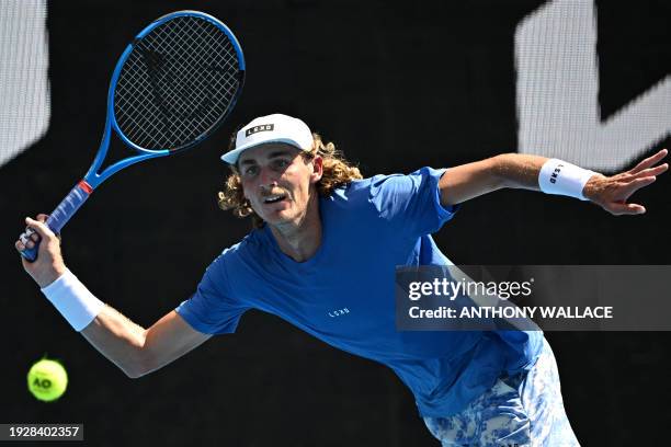 Australia's Max Purcell hits a return against Hungary's Mate Valkusz during their men's singles match on day three of the Australian Open tennis...