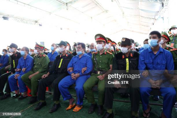 This photo taken and released by the Vietnam News Agency on January 16, 2024 shows defendants sitting during their trial in Vietnam's Dak Lak...