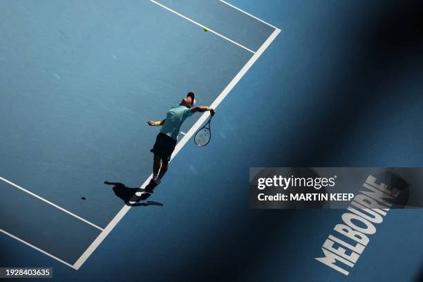 Japan's Yoshihito Nishioka serves against Denmark's Holger Rune during their men's singles match on day three of the Australian Open tennis...