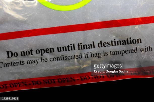 sealed bag for transporting duty free goods and other prohibited airline items - alcohol forbidden stock pictures, royalty-free photos & images