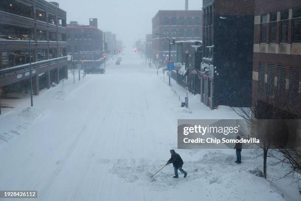 Man shovels snow into 3rd Street in downtown as high winds and snow from winter storm Gerri hit the capital four days before the Iowa caucuses on...