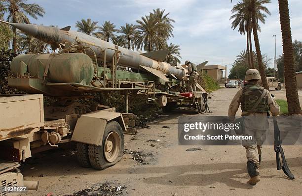 Army explosives experts dismantle an Iraqi surface-to-air SA-2 missile, left on the street April 12, 2003 in Baghdad, Iraq. U.S. Forces are now...