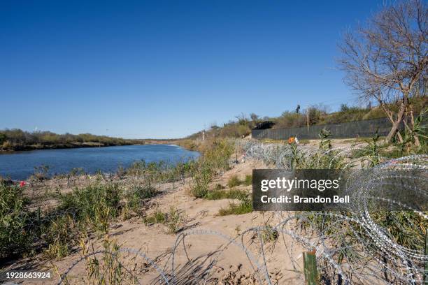 Razor wire is seen on the banks of the Rio Grande river at Shelby Park on January 12, 2024 in Eagle Pass, Texas. The Texas National Guard continues...