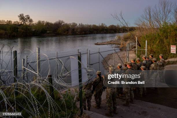 National Guard soldiers stand guard on the banks of the Rio Grande river at Shelby Park on January 12, 2024 in Eagle Pass, Texas. The Texas National...