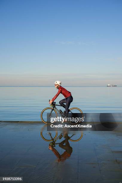 young man rides bicycle through tuscany countryside - koper slovenia stock pictures, royalty-free photos & images