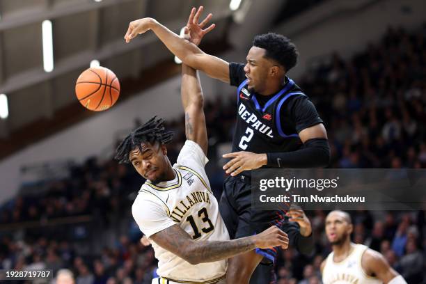 Chico Carter Jr. #2 of the DePaul Blue Demons blocks Hakim Hart of the Villanova Wildcats during the first half at Finneran Pavilion on January 12,...