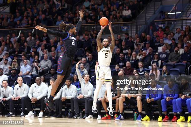 Justin Moore of the Villanova Wildcats shoots past Da'Sean Nelson of the DePaul Blue Demons during the first half at Finneran Pavilion on January 12,...