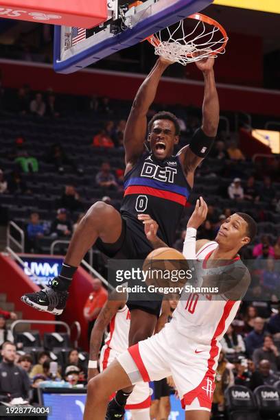 Jalen Duren of the Detroit Pistons dunks on top of Jabari Smith Jr. #10 of the Houston Rockets during the second half at Little Caesars Arena on...