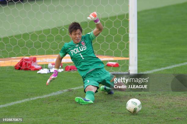 Shusaku Nishikawa of Urawa Red Diamonds saves the Gamba Osaka's fourth penalty kick taken by Hiroto Goya of Gamba Osaka at the penalty shootout...