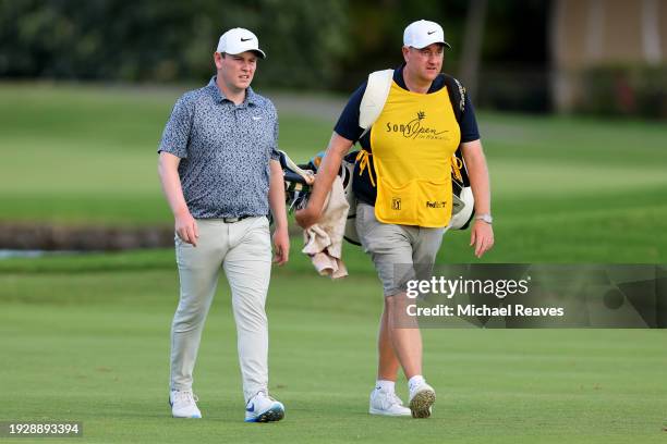 Robert MacIntyre of Scotland and his caddie, Mike Burrow, walk on the third hole during the second round of the Sony Open in Hawaii at Waialae...