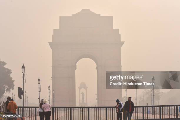 Commuters out on a cold and Fog morning amid rising air pollution levels at India Gate, on January 15, 2024 in New Delhi, India. Foggy morning...