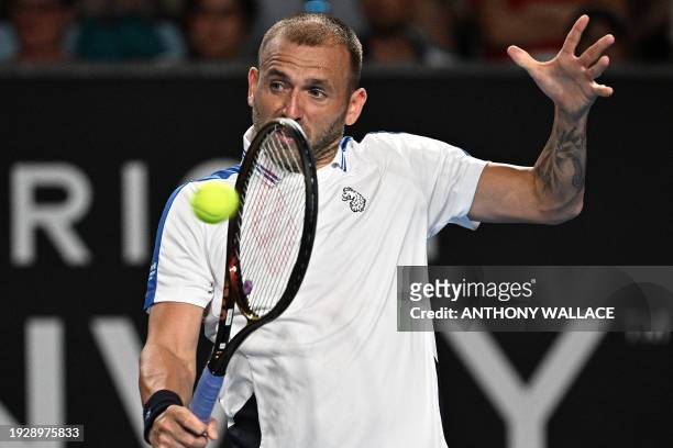 Britain's Daniel Evans hits a return against Italy's Lorenzo Sonego during their men's singles match on day three of the Australian Open tennis...