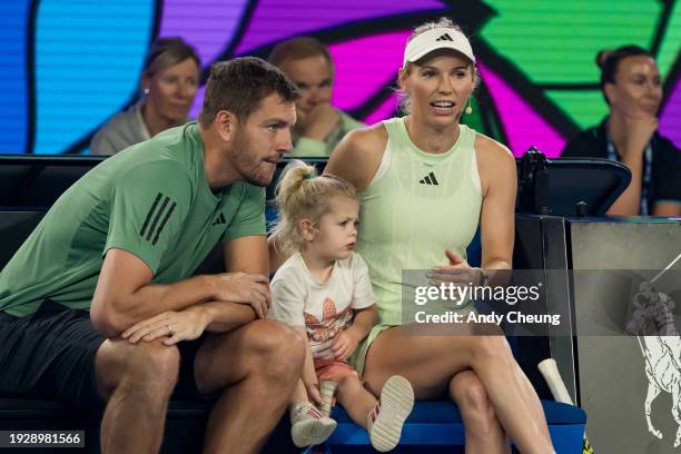 Caroline Wozniacki of Denmark sits with husband David Lee and daughter Olivia Lee during the Kids Tennis Day Arena Spectacular ahead of the 2024...