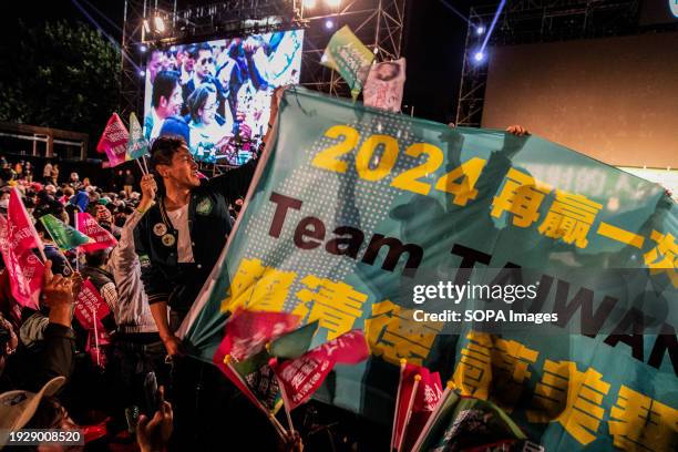 Supporters hold a banner that reads "2024 Win Again / Team Taiwan / Lai Ching-te and Hsiao Bi-khim" in Banqiao, New Taipei City. Last day before the...