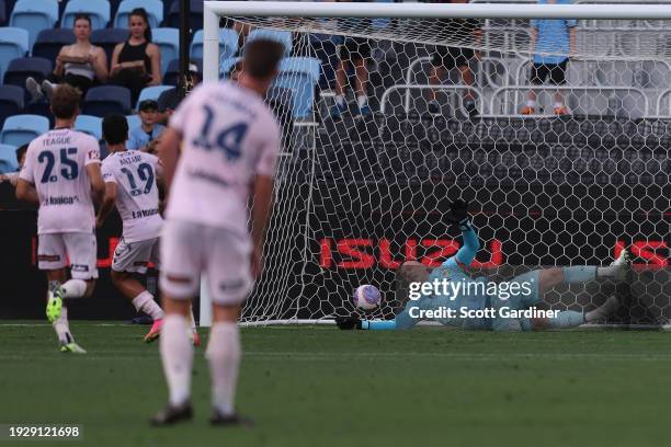 Daniel Arzani of Melbourne Victory scores a goal as Danny Vukovic of the Mariners dives for the ball during a penalty during the A-League Men round...