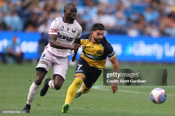 Christian Theoharous of the Mariners competes for the ball with Christopher Ikonomidis of Melbourne Victory during the A-League Men round 12 match...