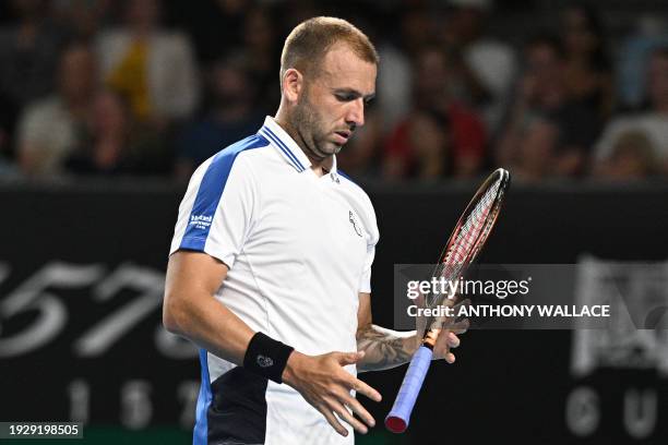 Britain's Daniel Evans prepare to serve against Italy's Lorenzo Sonego during their men's singles match on day three of the Australian Open tennis...