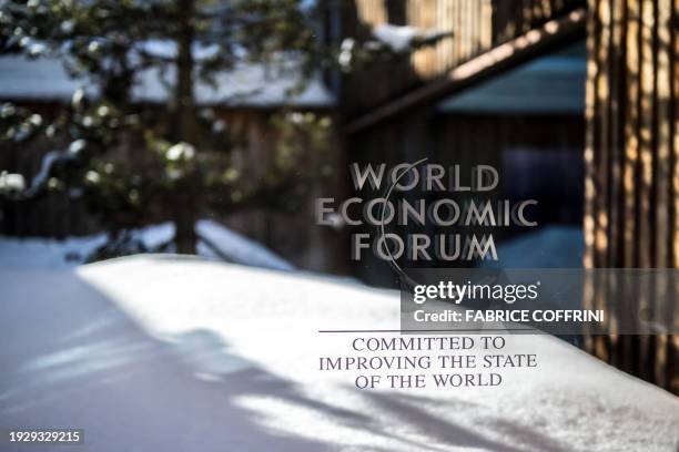 This photograph taken on January 16, 2024 shows a sign of the World Economic Forum displayed at the Congress center during WEF's annual meeting in...