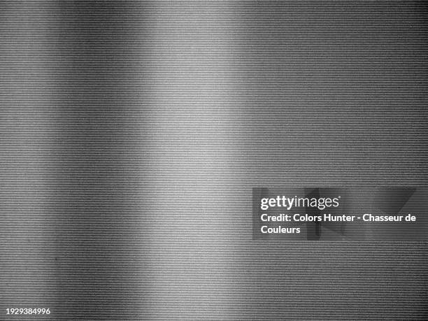 black and white close-up of grey lines on a white background of a backlit paper poster. paris, france. sunlight and shadow. - news background stock pictures, royalty-free photos & images