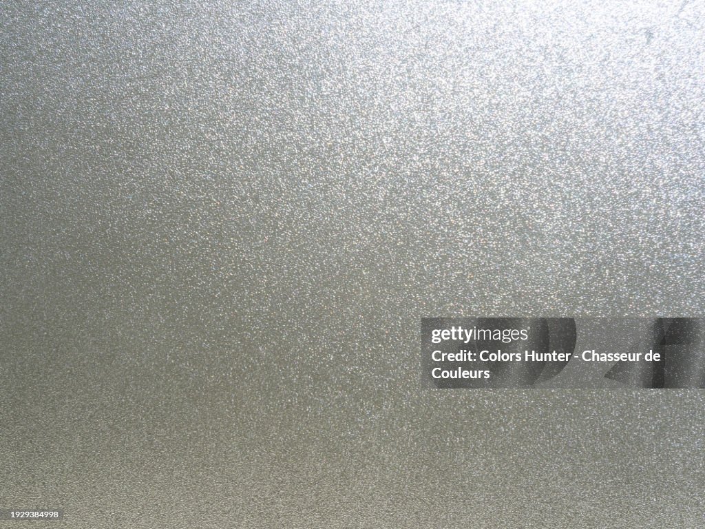 Close-up of an aluminum plate on which the sunlight is reflected. Smooth surface. Natural colors. Paris, France.